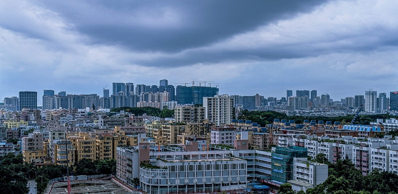 great shot of a modern city and a sky full of dark clouds